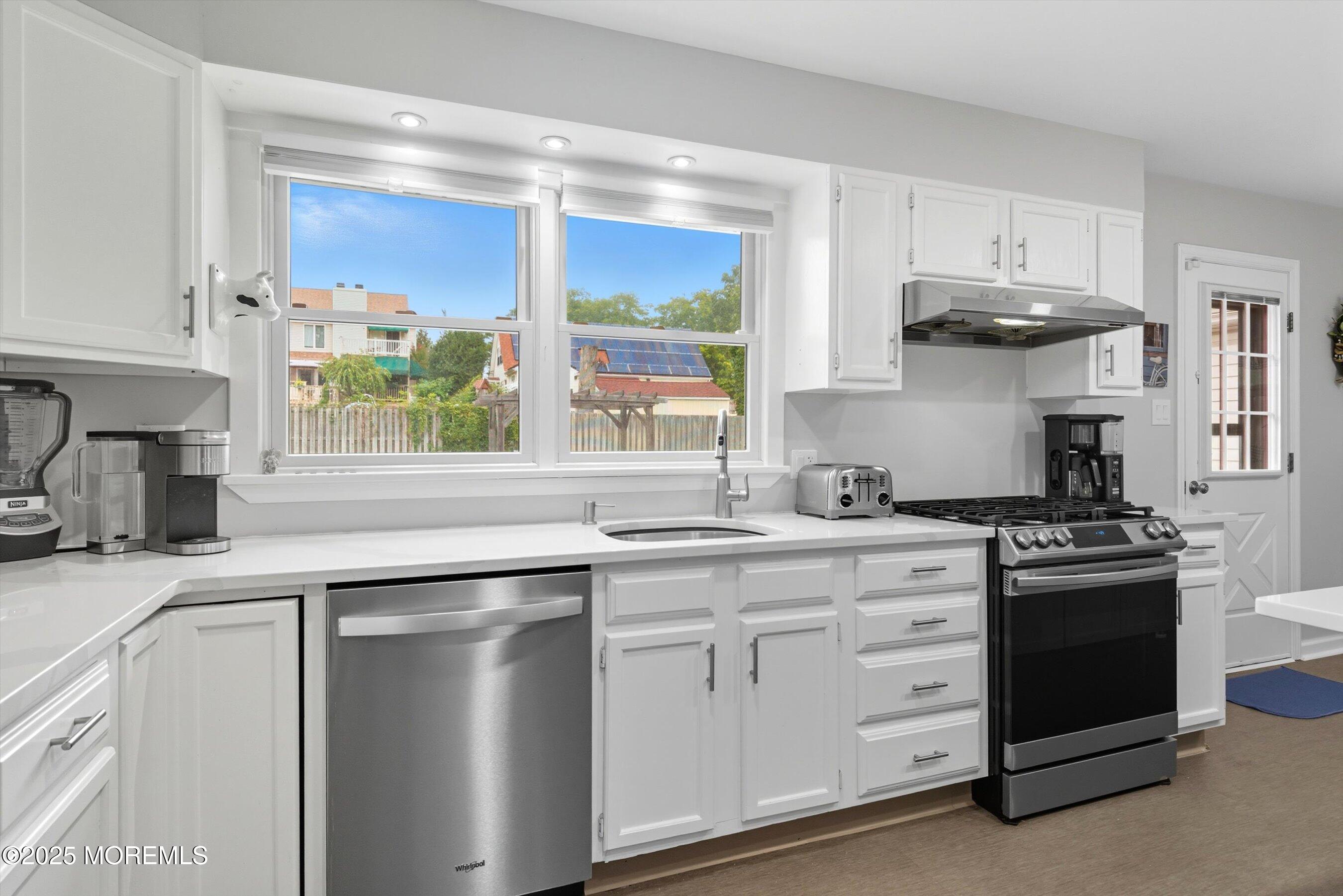 210 Coolidge Avenue Absecon, NJ 08201 - Photo 9 of 28 a kitchen with stainless steel appliances granite countertop a stove and a sink