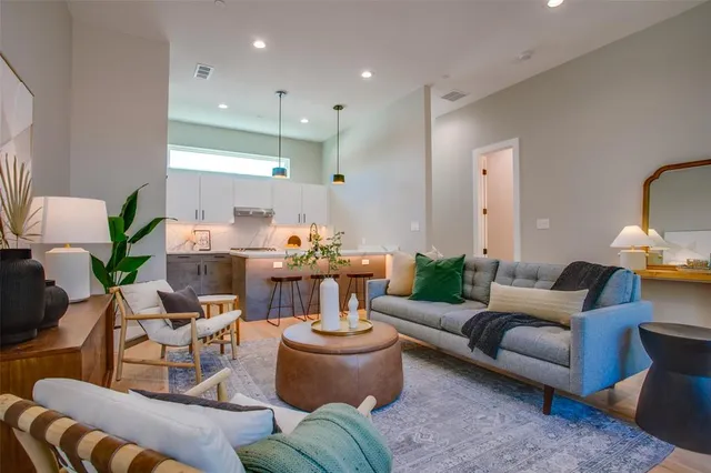 a living room with furniture and a potted plant