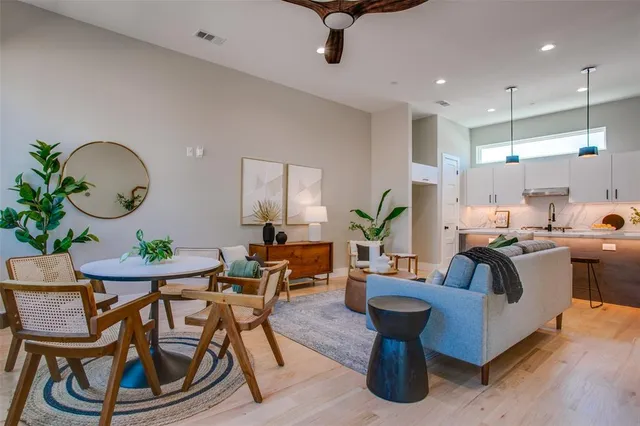 a living room with fireplace furniture and a large window