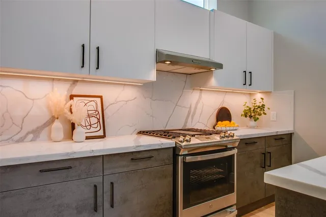 a view of a kitchen with stove and cabinets