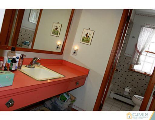 10 Bradford Road Edison, NJ 08820 - Photo 7 of 13 a room with furniture and a mirror