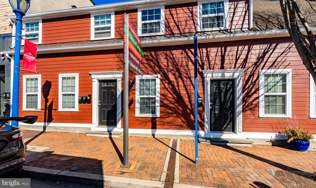 a view of brick house with large windows