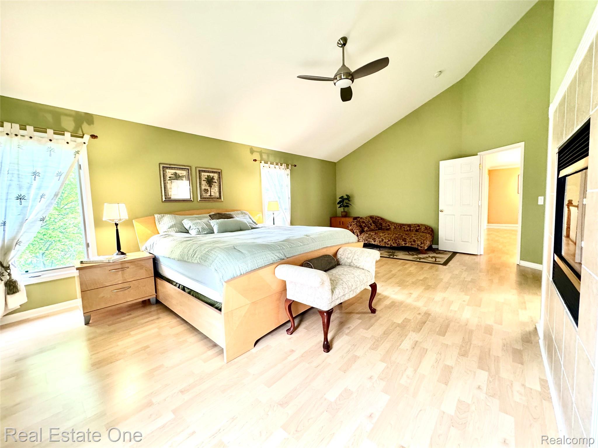 1215 Letica Drive Rochester, MI 48307 - Photo 15 of 43 Bedroom with lofted ceiling, light wood-type flooring, and a ceiling fan