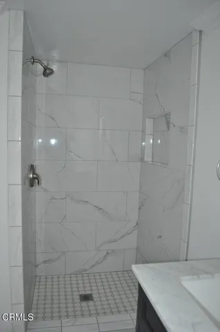 a bathroom with a sink vanity and mirror