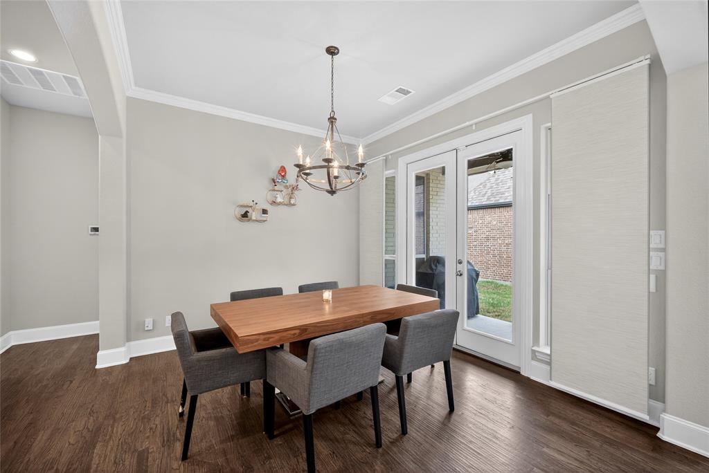 1039 Stephen Street Allen, TX 75013 - Photo 15 of 40 Dining room with french doors, ornamental molding, dark wood-type flooring, and suspended lighting
