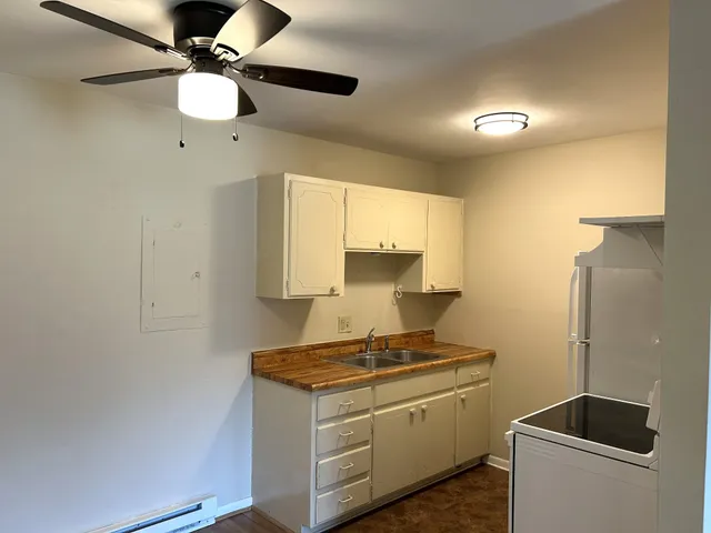 a kitchen with stainless steel appliances granite countertop a sink a stove and a refrigerator