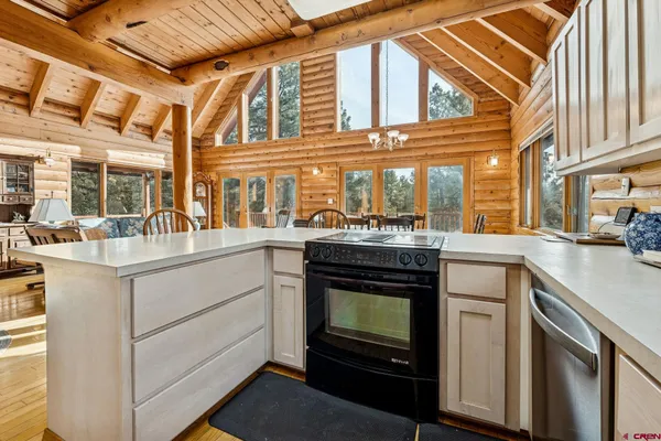 a kitchen with stove and cabinets