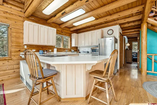 a dining room with furniture and a wooden floor