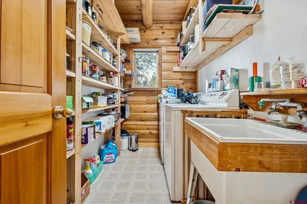 a utility room with sink dryer and washer