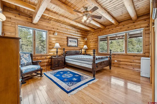 a living room with furniture a wooden floor and next to a window