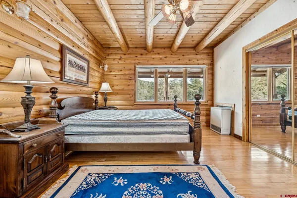 a view of an entryway with wooden floor and a rug