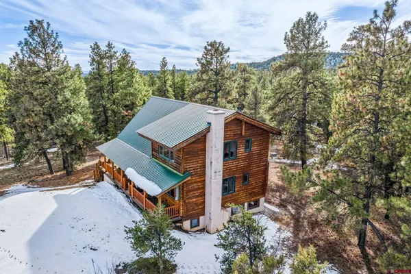 an aerial view of a house with a yard