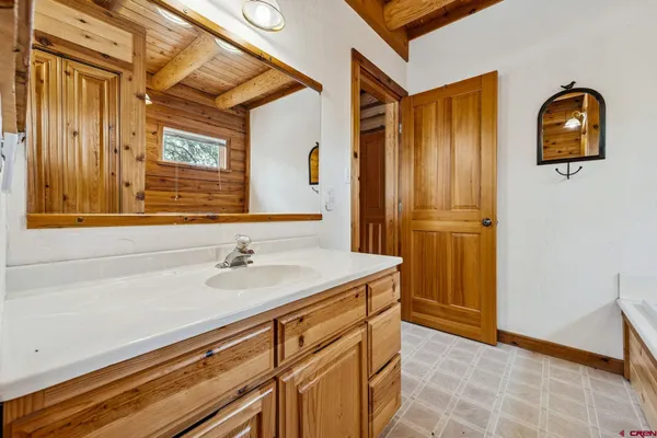 a bathroom with a sink a vanity and a mirror