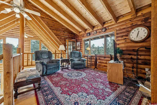 a living room with furniture and a clock