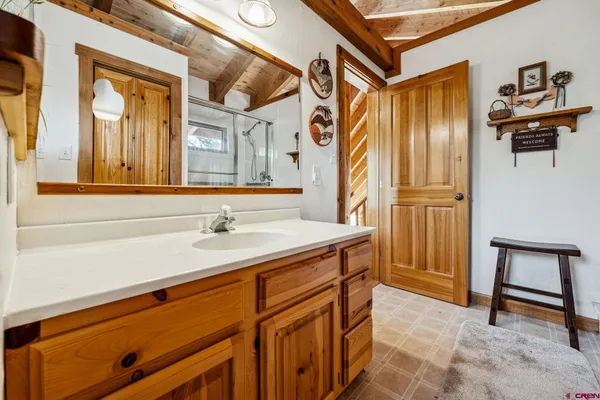 a bathroom with a sink a mirror and a shower