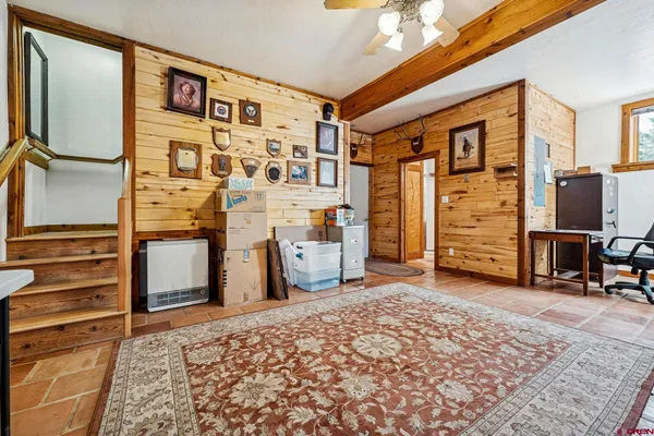 a view of a bedroom with furniture and window