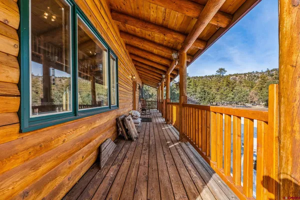 a balcony with chairs and wooden floor