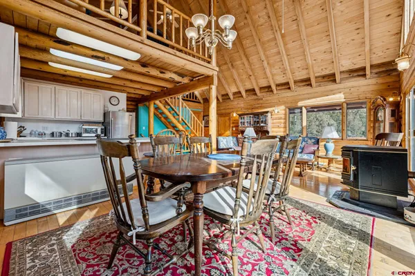 a view of a dining room with furniture and a fireplace
