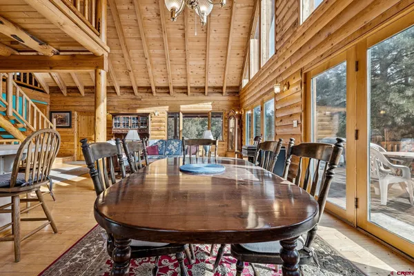 a dining room with furniture a rug and wooden floor