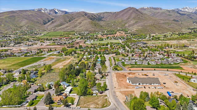 123 West 1050th North, Unit 41 Midway, UT 84049 - Photo 17 of 22 Expansive residential area with a mix of established homes and new construction, set against a backdrop of mountains with visible snow caps