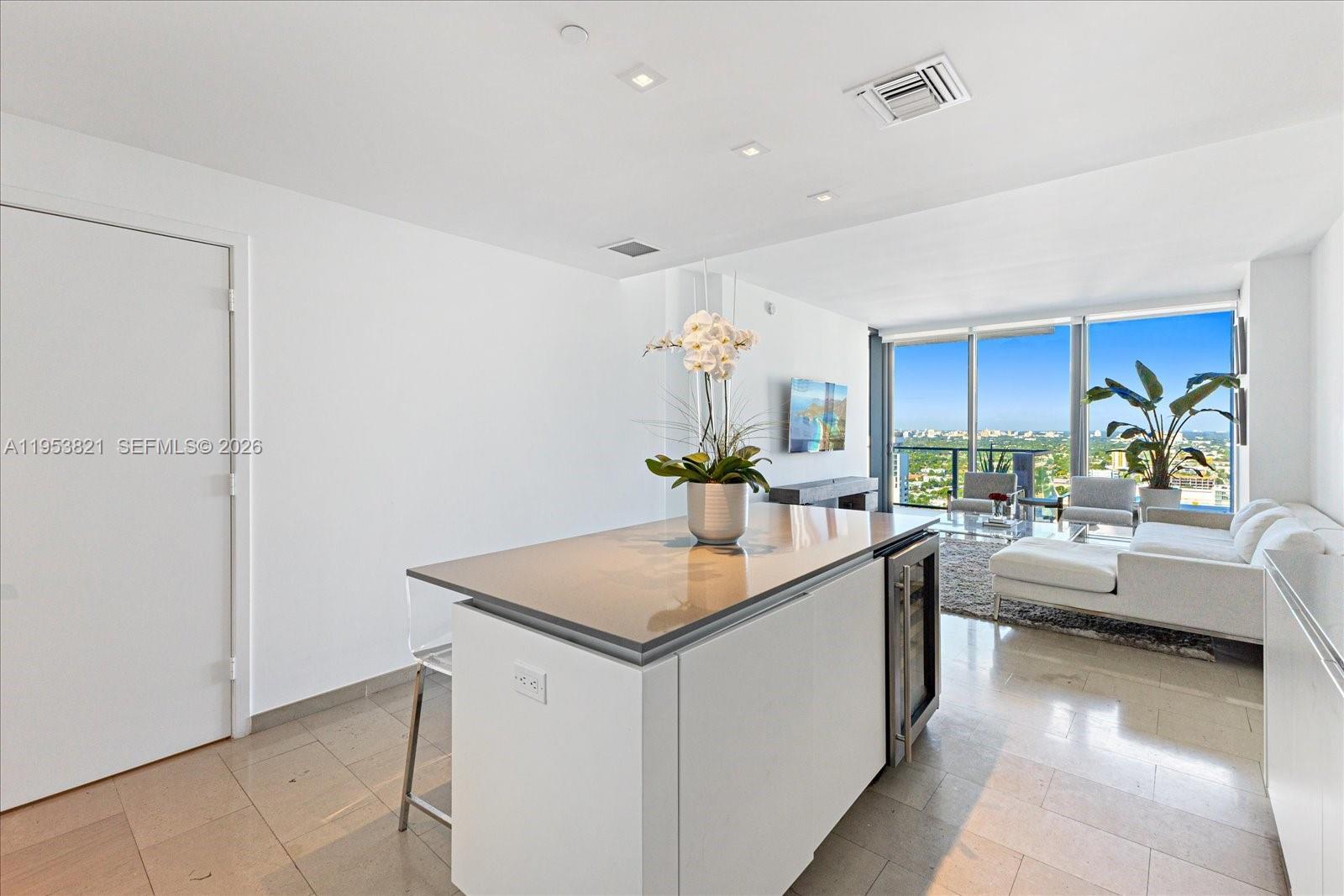 88 Southwest 7th Street, Unit 2506 Miami, FL 33130 - Photo 11 of 32 a living room with stainless steel appliances furniture a chandelier and a kitchen view