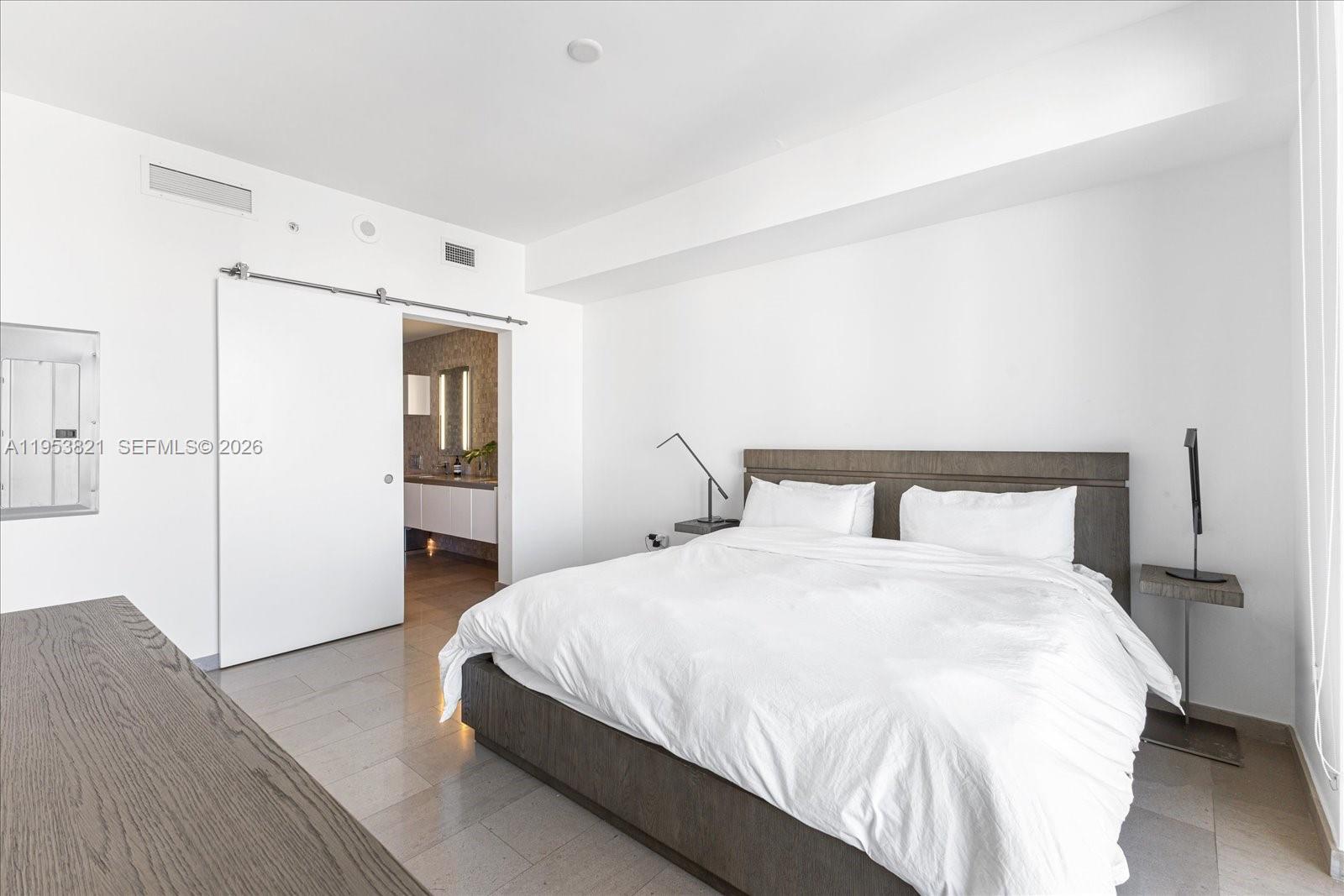 88 Southwest 7th Street, Unit 2506 Miami, FL 33130 - Photo 12 of 32 a bedroom with a bed and a closet