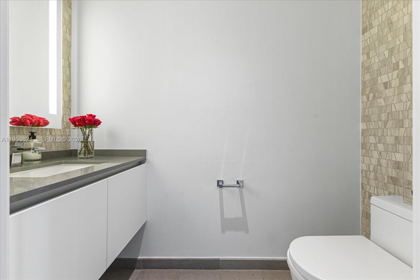 88 Southwest 7th Street, Unit 2506 Miami, FL 33130 - Photo 20 of 32 a bathroom with a sink and a toilet