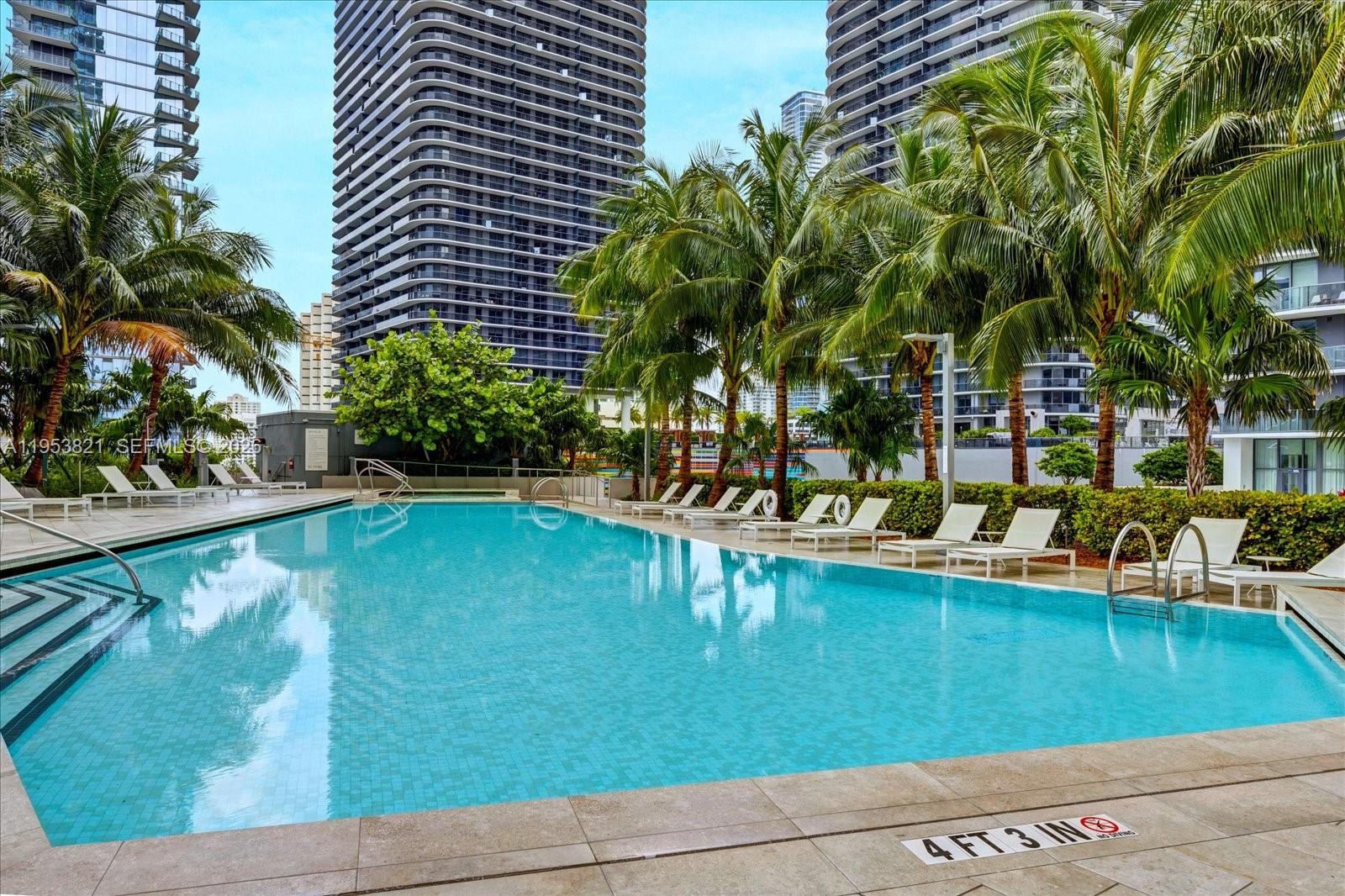 88 Southwest 7th Street, Unit 2506 Miami, FL 33130 - Photo 26 of 32 a view of swimming pool with outdoor seating and plants