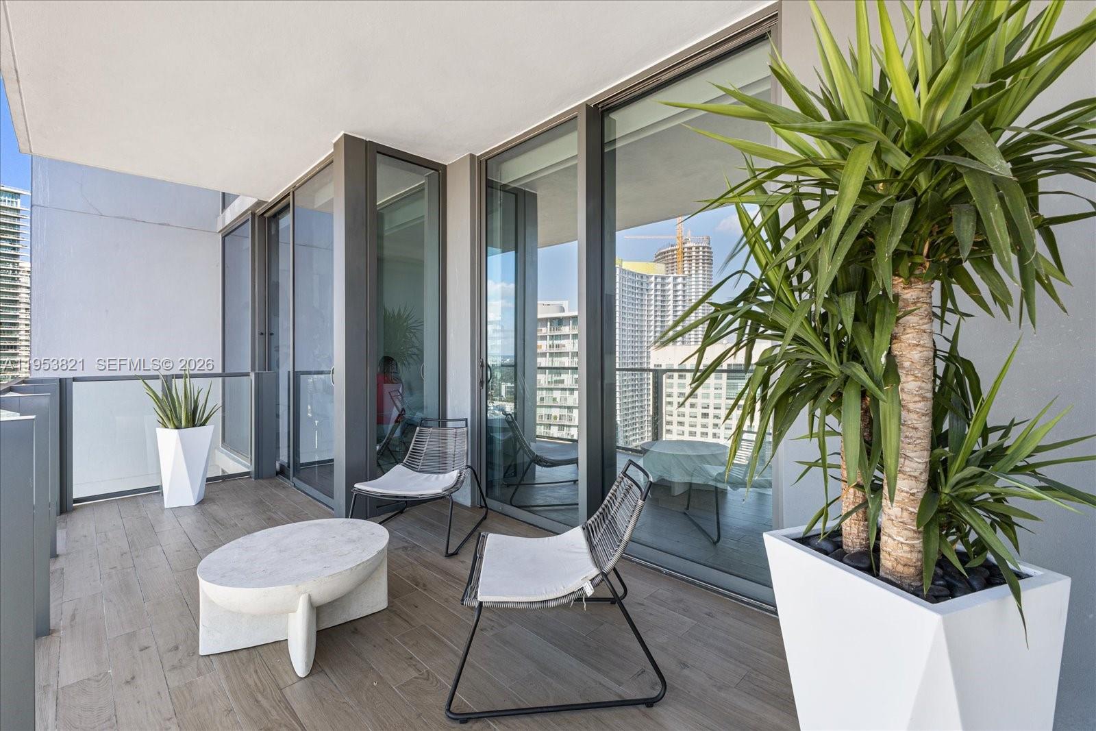 88 Southwest 7th Street, Unit 2506 Miami, FL 33130 - Photo 3 of 32 a living room with furniture and a potted plant