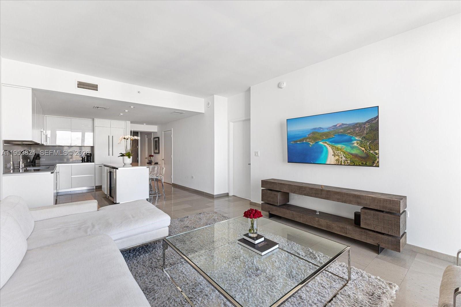 88 Southwest 7th Street, Unit 2506 Miami, FL 33130 - Photo 6 of 32 a living room with furniture and a rug