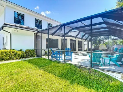 a kitchen with a dining table chairs stainless steel appliances and cabinets