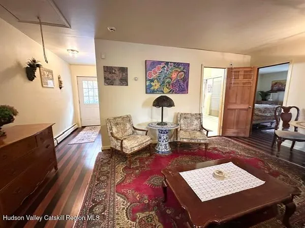 a dining room with furniture and wooden floor
