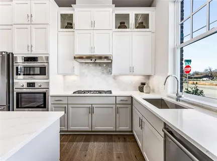 a kitchen with stainless steel appliances granite countertop a stove and a sink