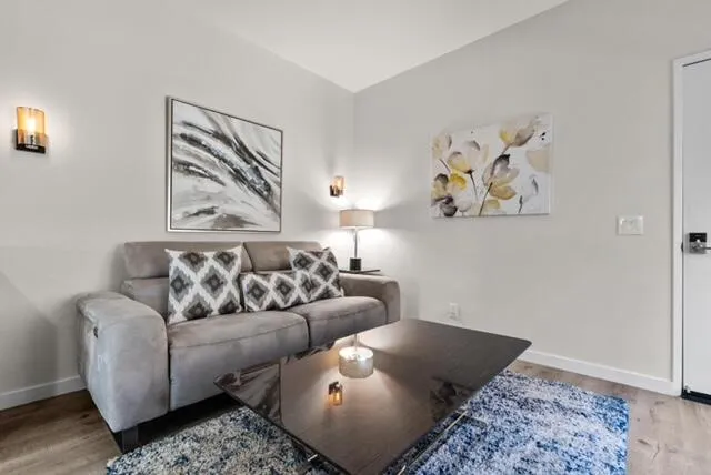 a living room with furniture and wall painting