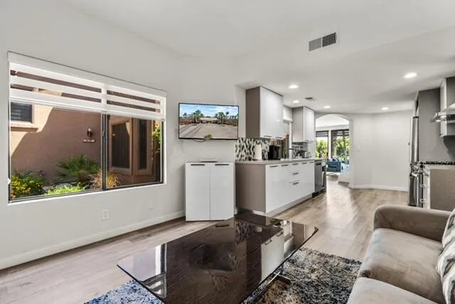 a living room with furniture and a large window