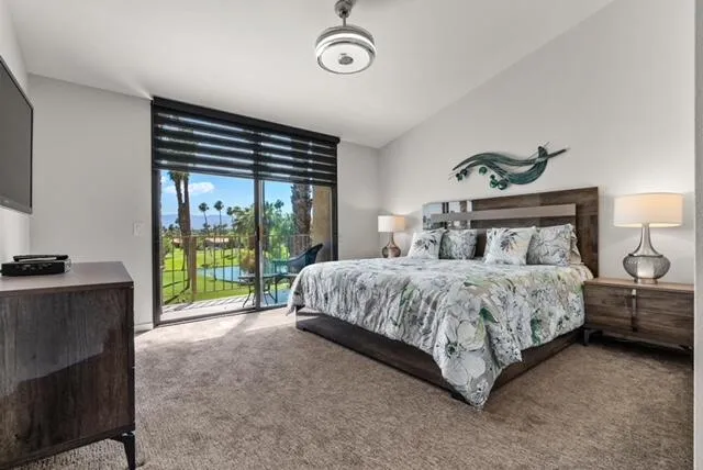 a bedroom with a bed and a television