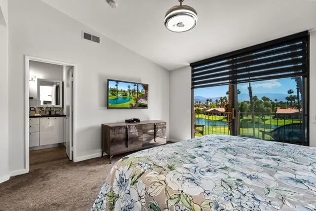 a bed sitting in a bedroom next to a window