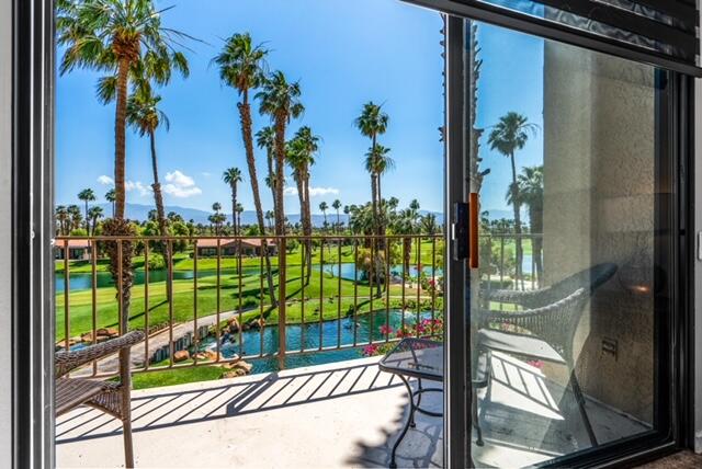 38101 Crocus Lane Palm Desert, CA 92211 - Photo 5 of 28 a view of a porch with a floor to ceiling window and potted plants