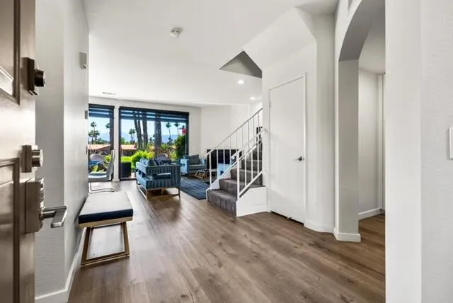 a living room with furniture and a wooden floor