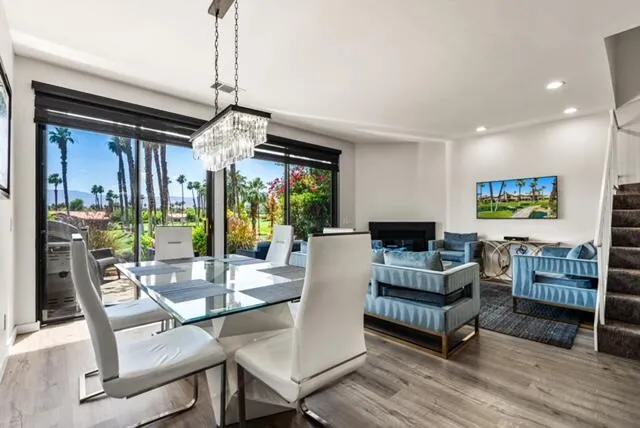 a living room with fireplace furniture and a chandelier