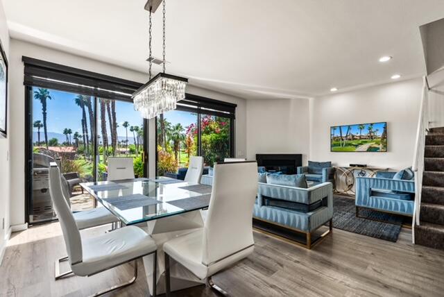38101 Crocus Lane Palm Desert, CA 92211 - Photo 8 of 28 a living room with fireplace furniture and a chandelier