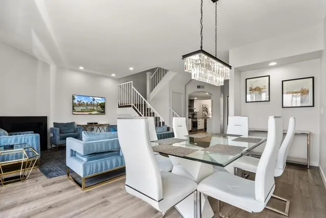 a view of a livingroom with furniture wooden floor and a chandelier