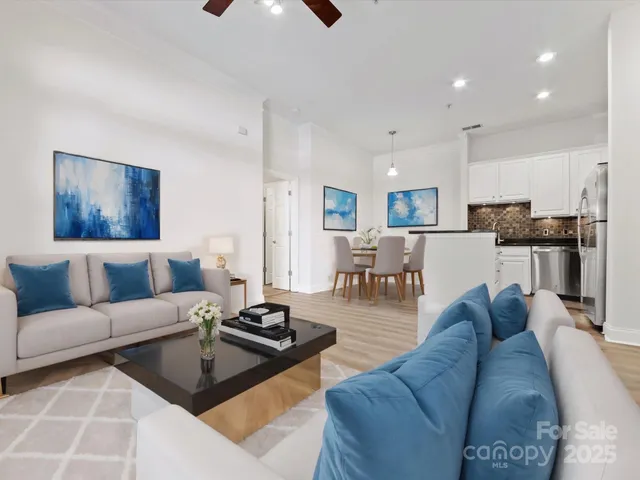 a living room with furniture and kitchen view