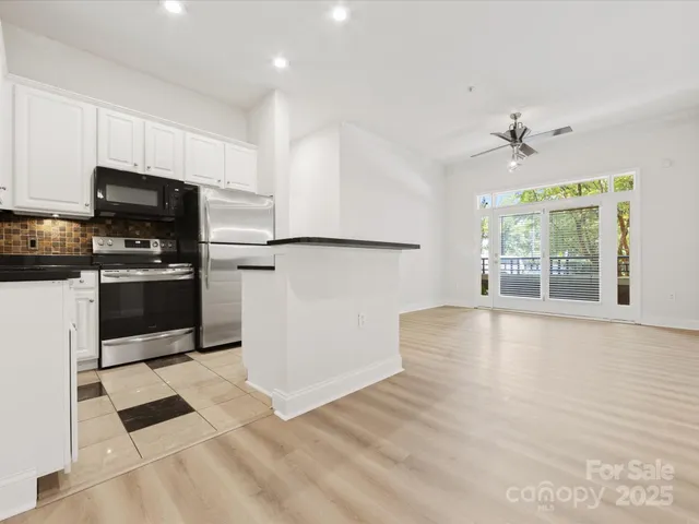 a view of a kitchen with a stove cabinets and a ceiling fan