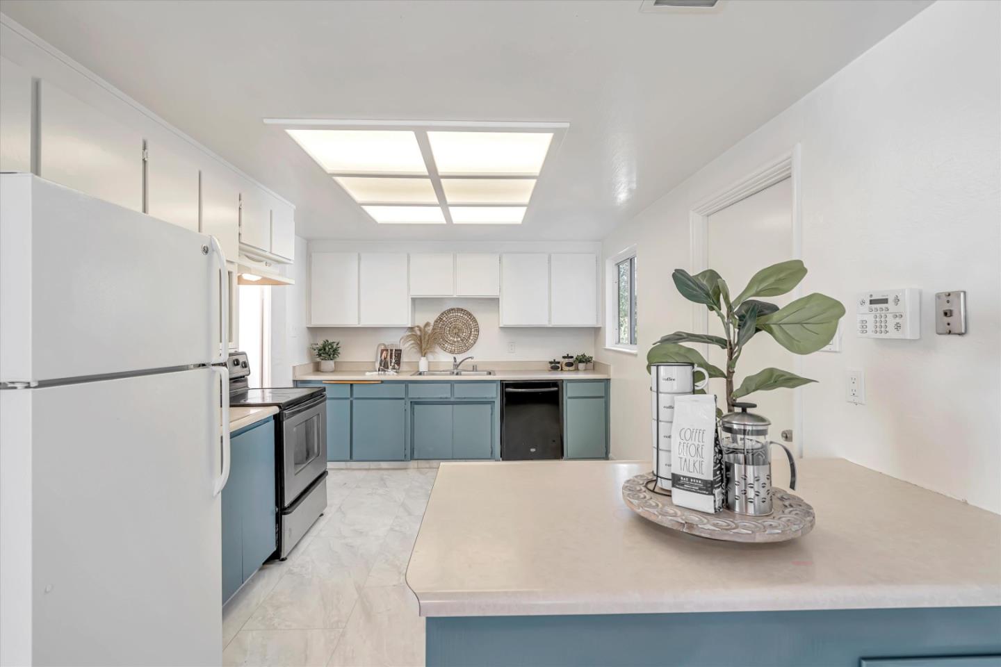 1041 Hargus Avenue Vallejo, CA 94591 - Photo 12 of 35 a kitchen with kitchen island white cabinets and refrigerator