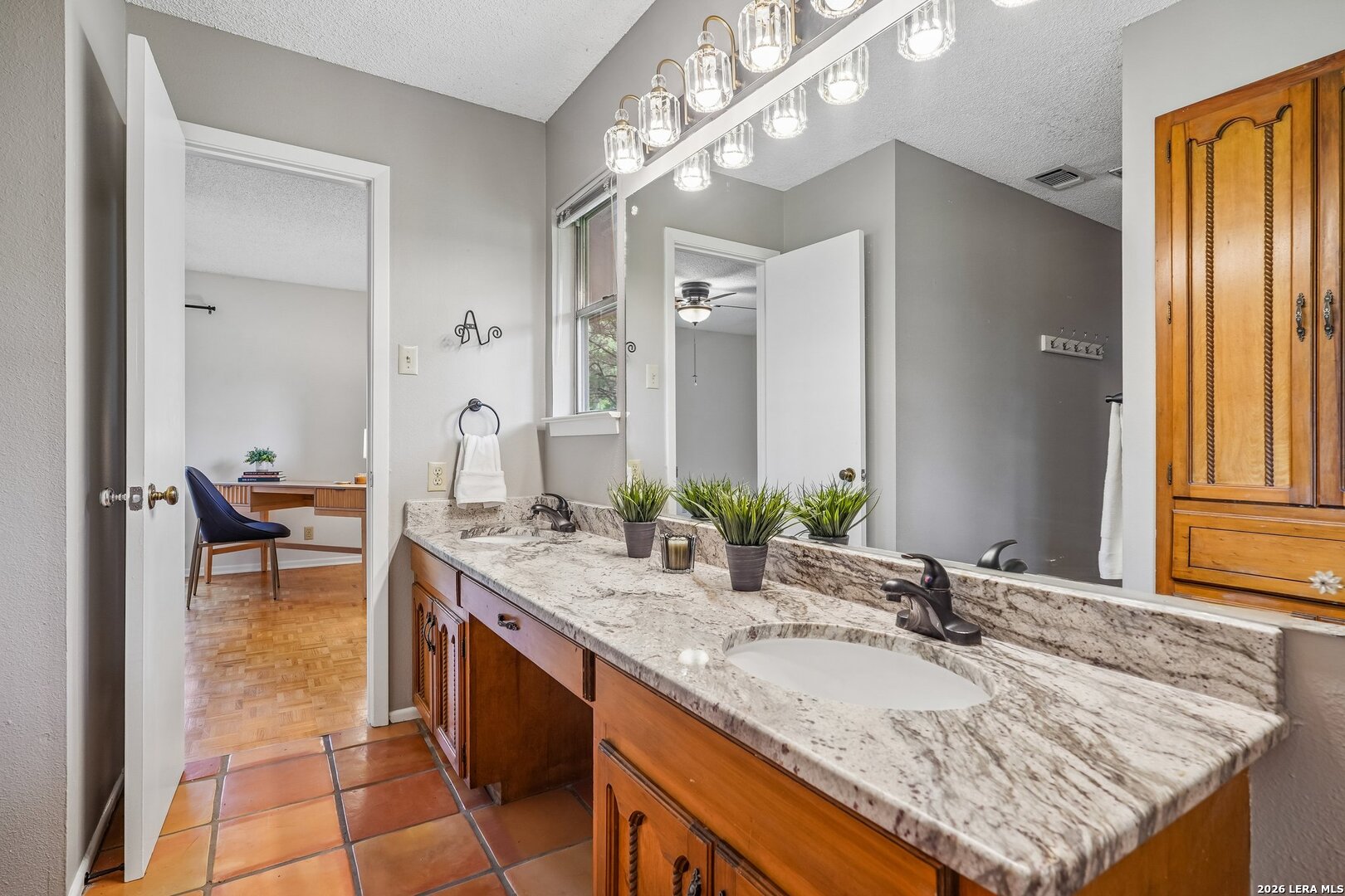 20632 Timber Rose Drive Garden Ridge, TX 78266 - Photo 28 of 46 a bathroom with a granite countertop sink and a mirror