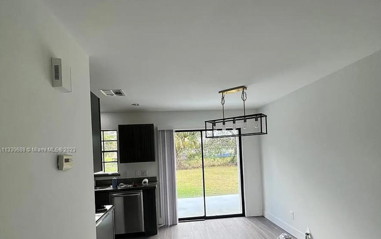 841 Northwest Riverside Drive Port St. Lucie, FL 34983 - Photo 5 of 17 Dinning to kitchen