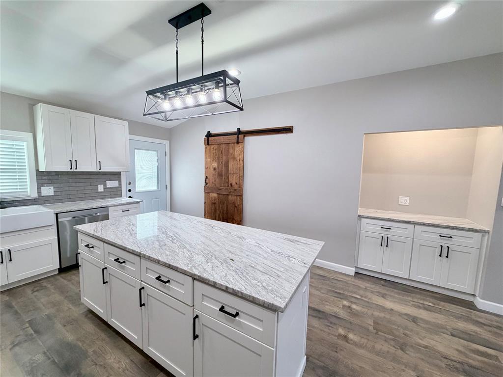 710 North Rusk Street Weatherford, TX 76086 - Photo 10 of 30 large island with matching granite top. Under cabinets, perfect for storage.
