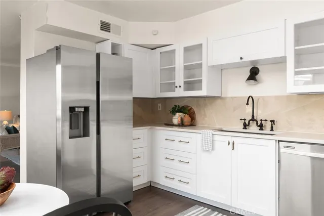 a kitchen with stainless steel appliances a refrigerator and cabinets