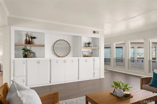 a living room with furniture flowerpot and wooden floor